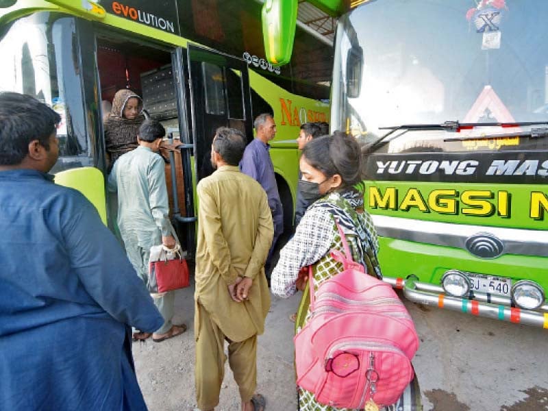 people board a bus at an inter city terminal in karachi photo jalal qureshi express