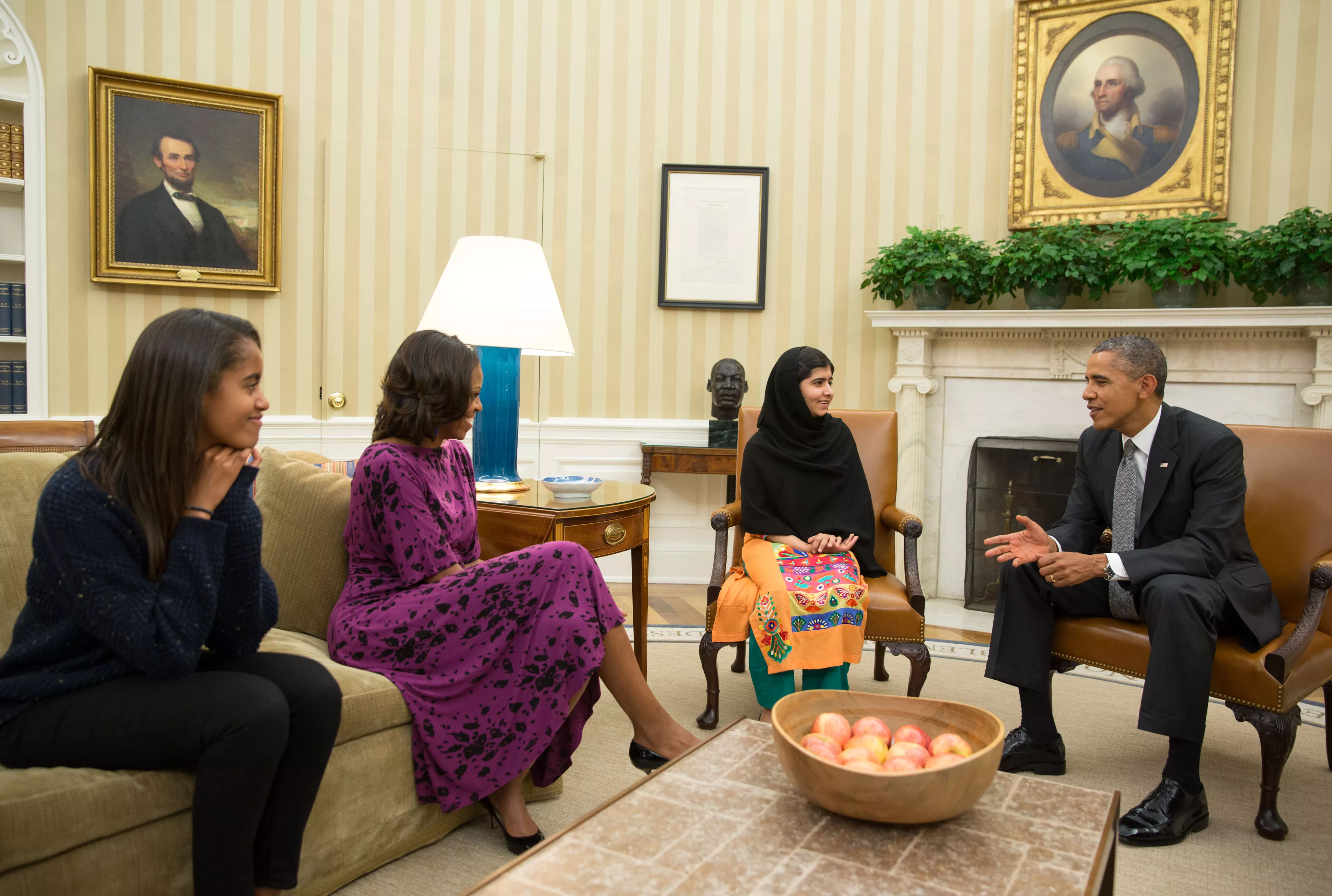 malala c listens to us president barack obama r in the oval office of the white house on friday as michelle obama 2nd l and malia l look on photo white house