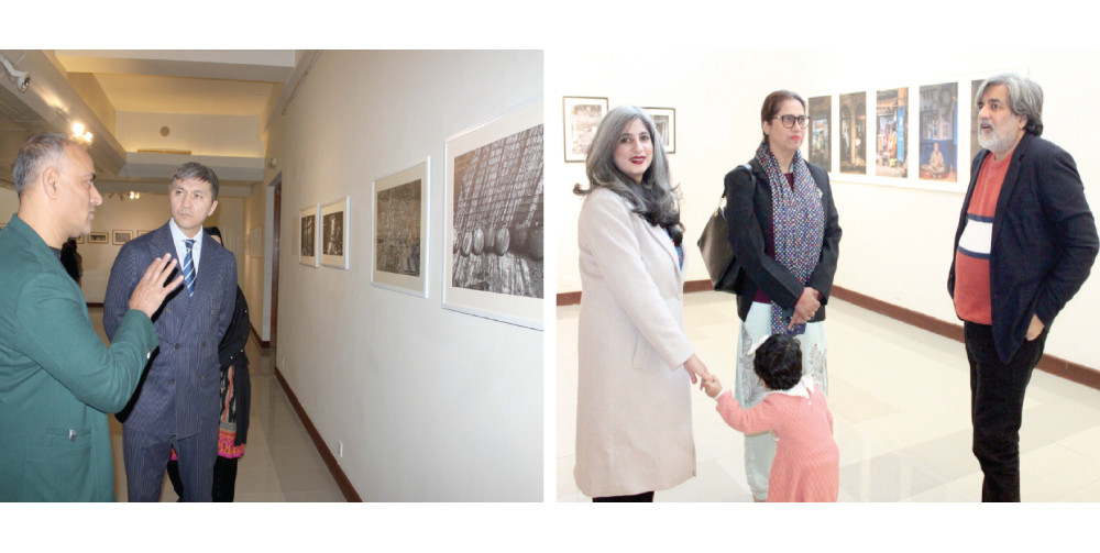 visitors take keen interest in the photographs on display at pnca photo express