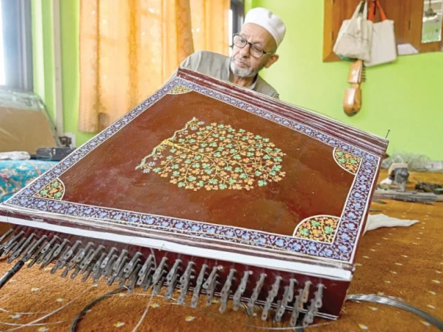 artisan ghulam mohammad zaz makes the santoor at his home in srinagar photo afp