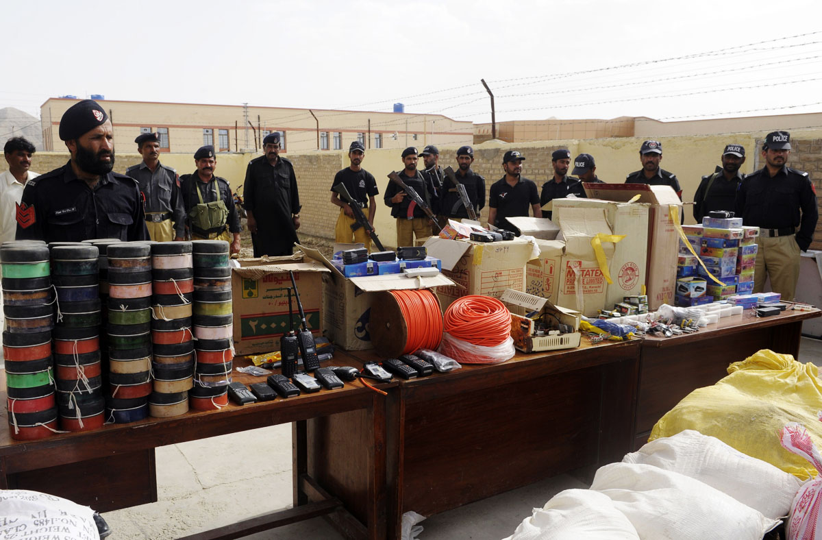 pakistani police officials stand beside seized explosive material on display in quetta photo afp file