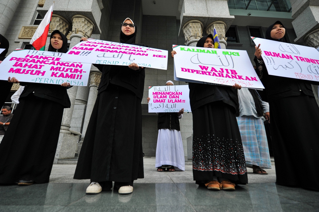 protesters display placards during a demonstration at the court of appeal in putrajaya photo afp