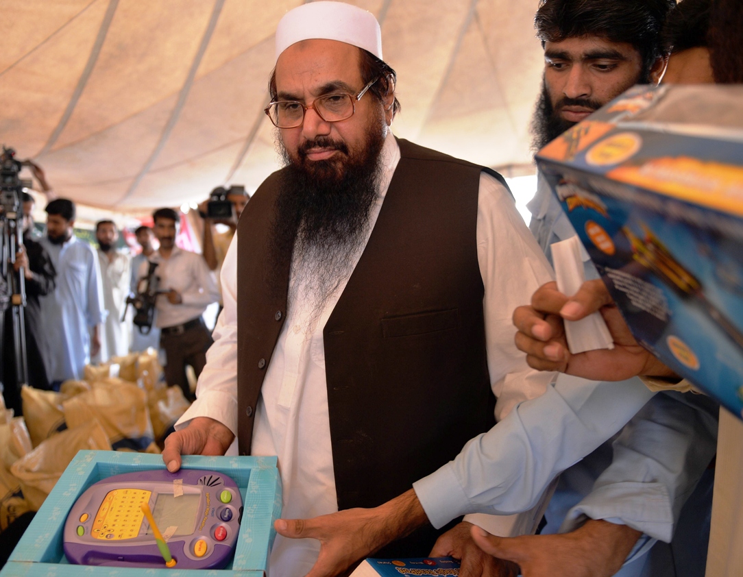 hafiz mohammad saeed looks at relief supplies for earthquake survivors in islamabad on october 14 2013 photo afp