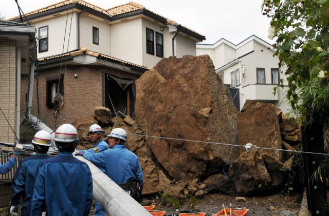 rescue workers work to remove an electric pole that was knocked down by boulders as typhoon wipha passed through kamakura in kanagawa prefecture in japan photo afp rescue workers work to remove an electric pole that was knocked down by boulders as typhoon wipha passed through kamakura in kanagawa prefecture in japan photo afp