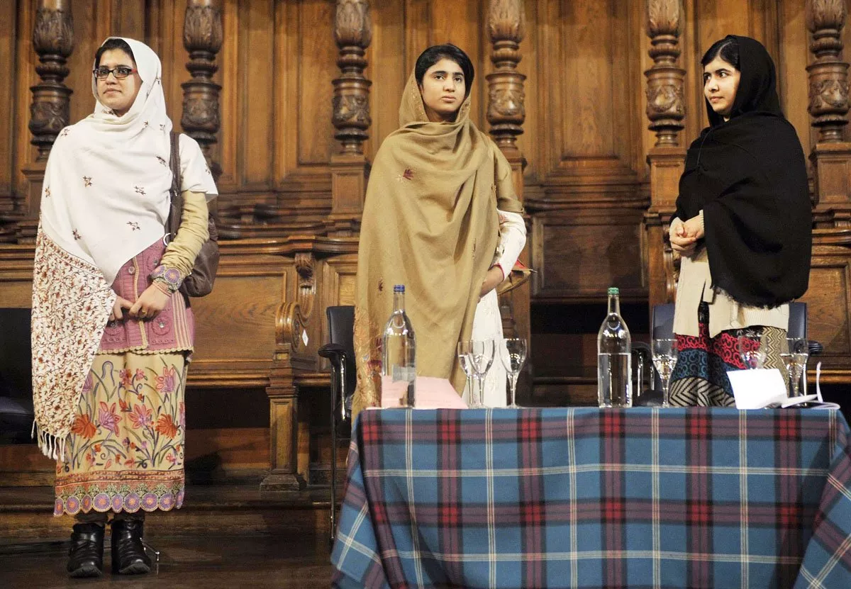 three friends bonded by blood malala yousafzai r stands next to her school friends kainat riaz l and shazia ramzan c during the first global citizenship commission meeting at the university of edinburgh in scotland on october 19 2013 photo afp three friends bonded by blood malala yousafzai r stands next to her school friends kainat riaz l and shazia ramzan c during the first global citizenship commission meeting at the university of edinburgh in scotland on october 19 2013 photo afp