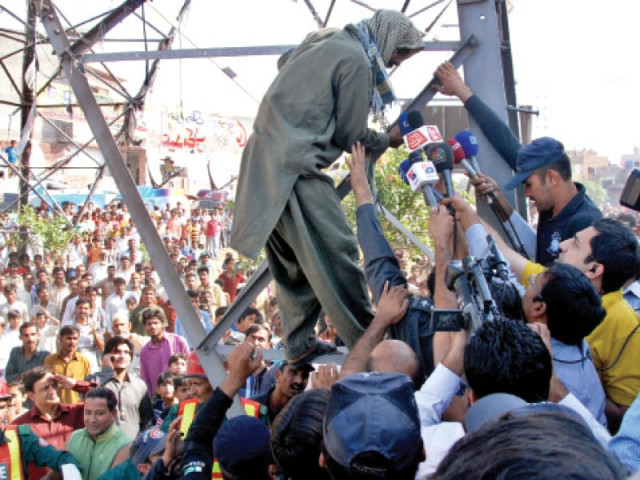 shabbir ail is swamped by police and media as he climbs down photo abid nawaz express shabbir ail is swamped by police and media as he climbs down photo abid nawaz express