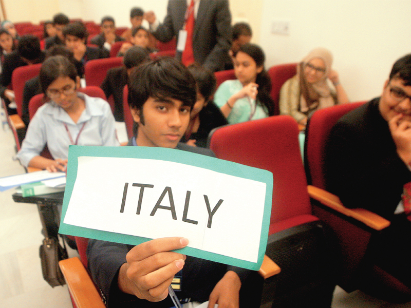 students from over 15 o and a level schools and colleges in the city participated in the bay view college s academic simulation of the united nations on sunday top a student holds a flag of india to represent his member state in a replicated session of the un at the conference left photo athar khan express