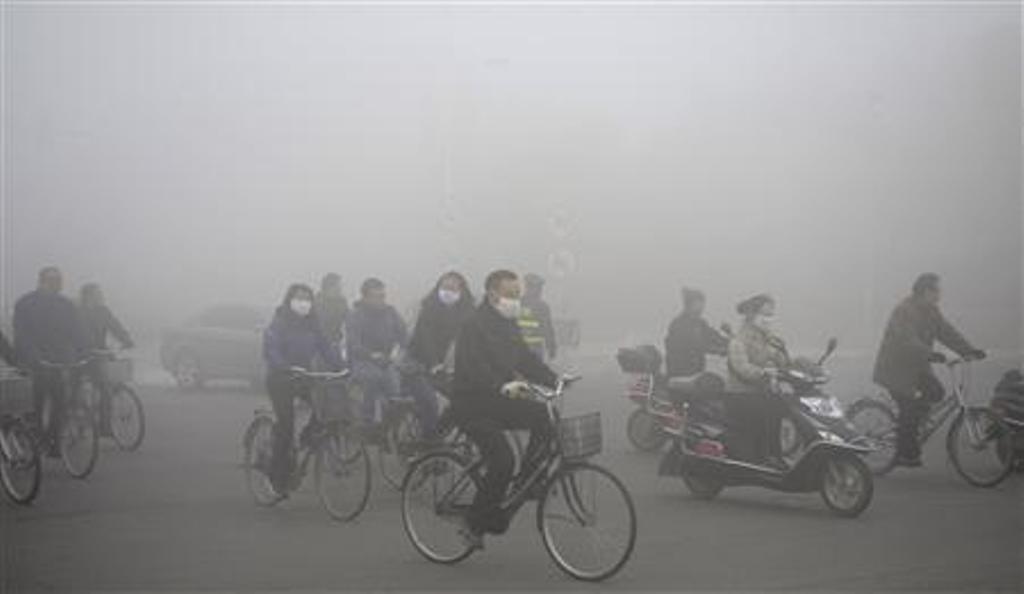 people ride along a street on a smoggy day daqing heilongjiang province on october 21 2013 photo reuters