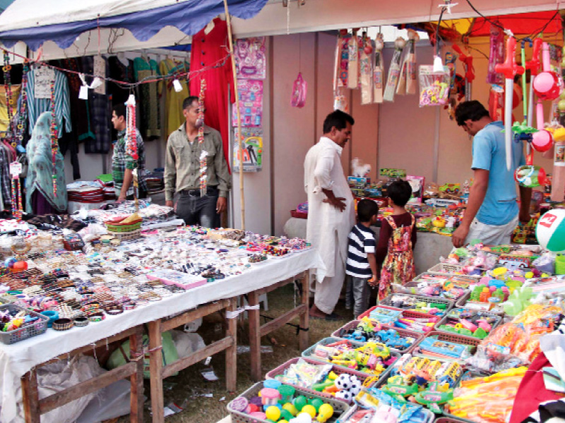 children visit a toy stall at the mela photo shafiq malik expres