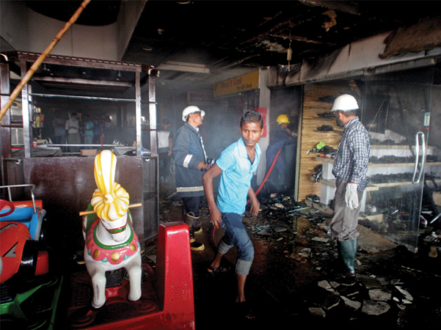 shoppers at millenium mall in gulshan e iqbal witnessed chaos on wednesday afternoon when a shoe outlet caught fire and the resulting smoke engulfed the entire building photo athar khan express shoppers at millenium mall in gulshan e iqbal witnessed chaos on wednesday afternoon when a shoe outlet caught fire and the resulting smoke engulfed the entire building photo athar khan express