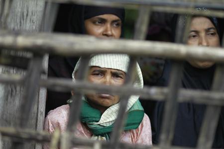 rohingya muslim women look out from their home at aung mingalar quarter in sittwe photo reuters