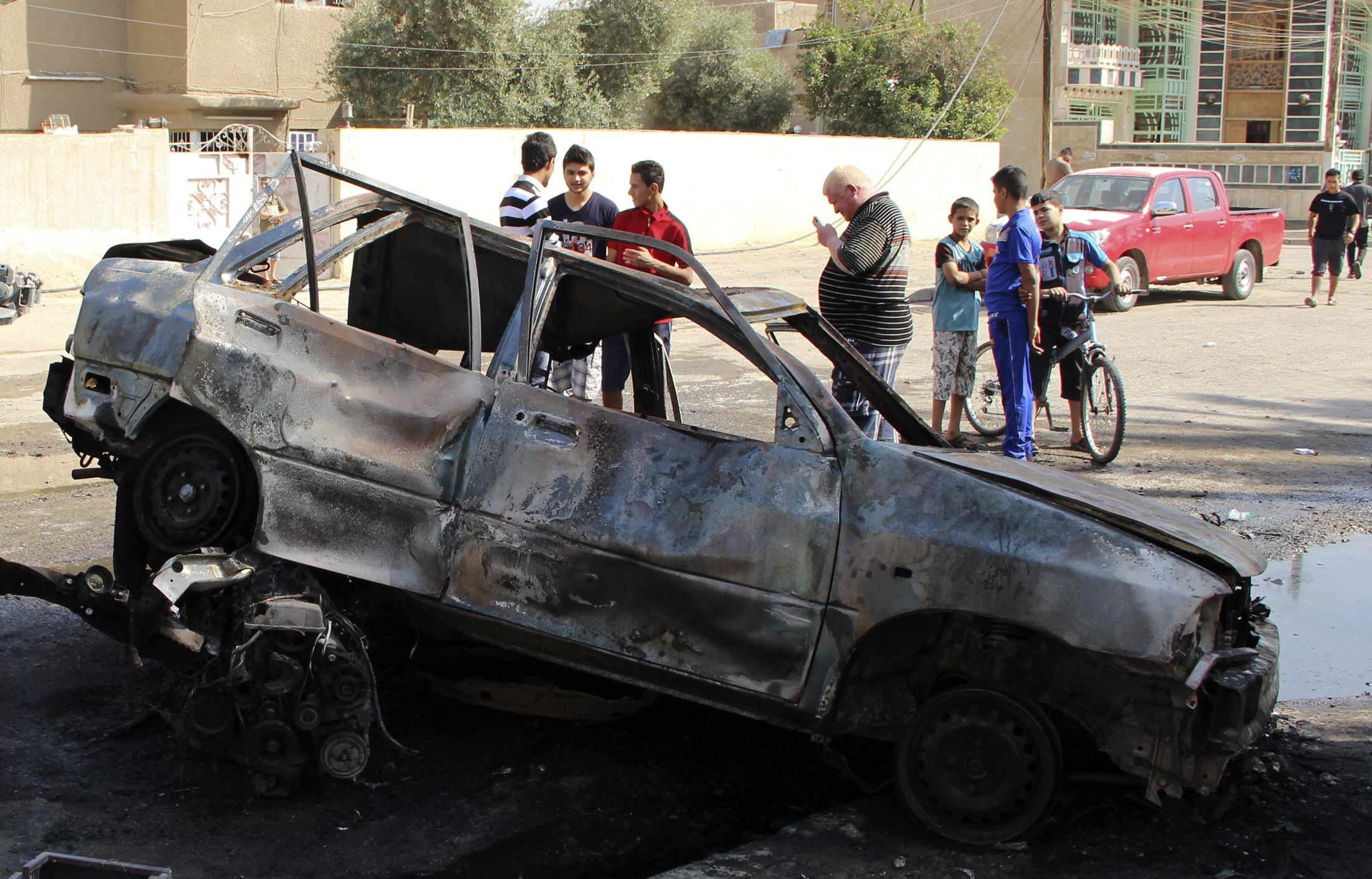 people gather at the site of a car bomb attack in baghdad october 27 2013 photo reuters