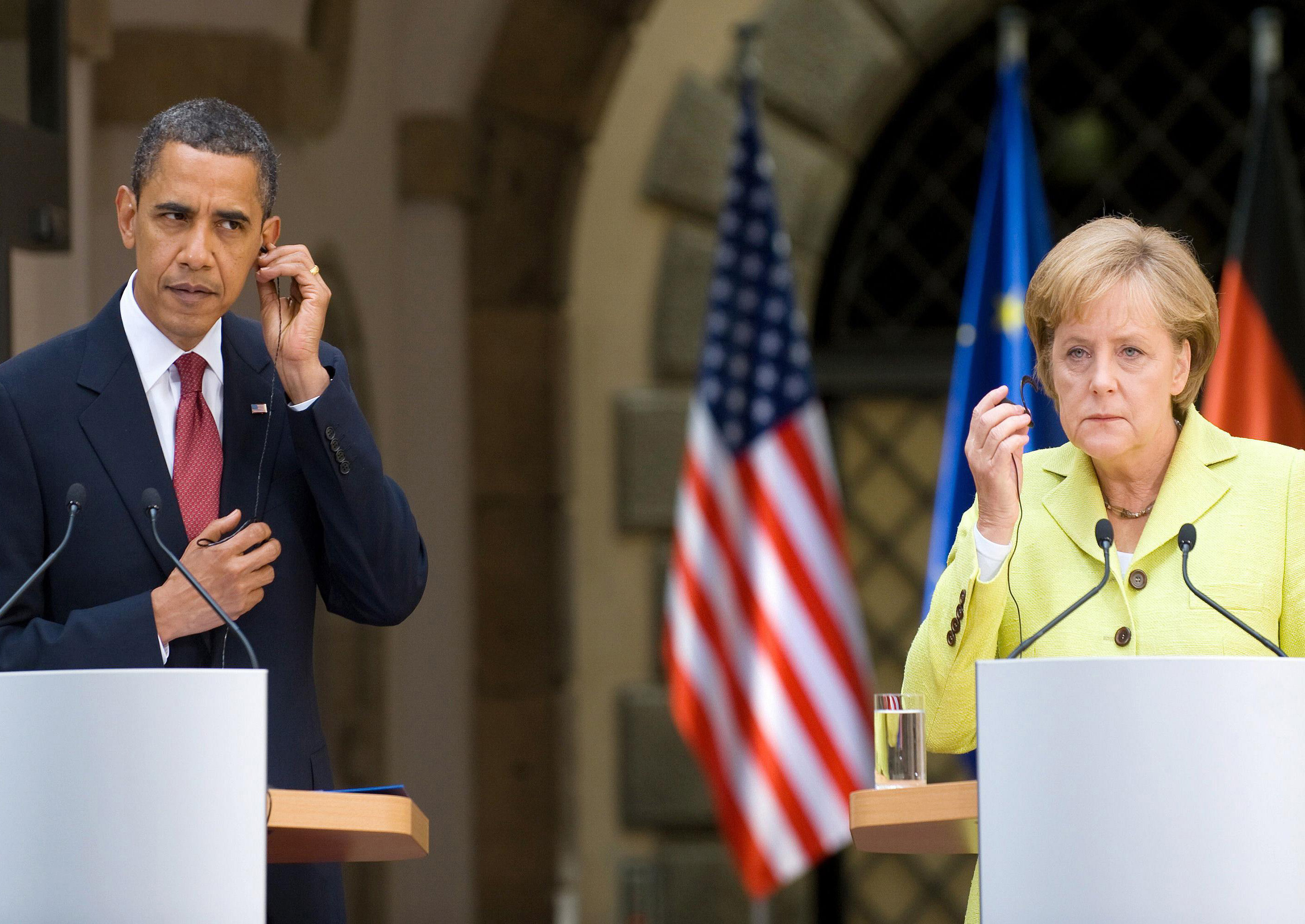 this picture taken on june 5 2009 shows us president barack obama and german chancellor angela merkel listening to translations during a press conference at dresden castle in the center of the eastern german town of dresden photo afp