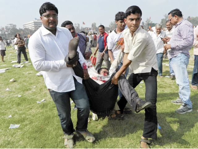 police transfer an injured man after a bomb exploded in the rally of bjp leader narendra modi in the eastern indian city of patna photo reuters police transfer an injured man after a bomb exploded in the rally of bjp leader narendra modi in the eastern indian city of patna photo reuters