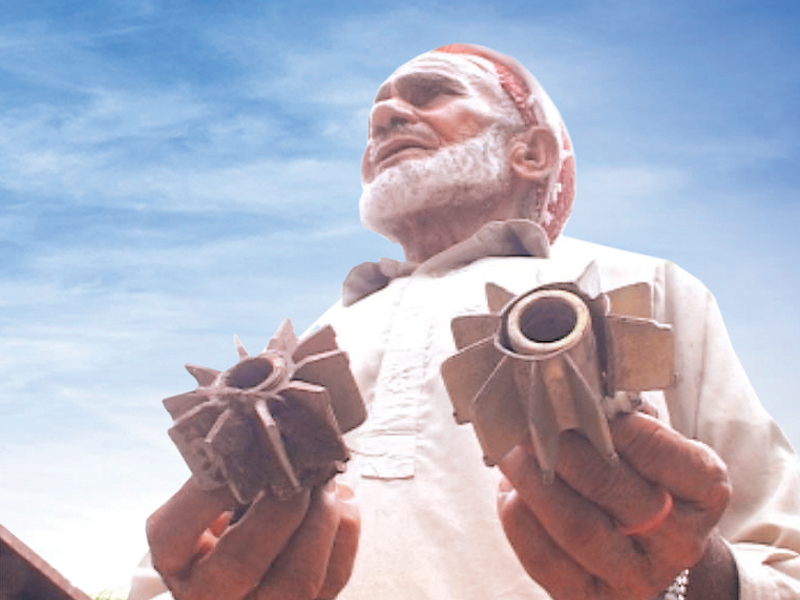 an old man shows pieces of mortar shells fired by the indian forces into a kashmir village photo express