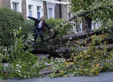 theo harcourt a 13 year old student jumps over a fallen tree as he makes his way to school in islington after strong storm winds and rain battered southern parts of england and wales photo reuters theo harcourt a 13 year old student jumps over a fallen tree as he makes his way to school in islington after strong storm winds and rain battered southern parts of england and wales photo reuters