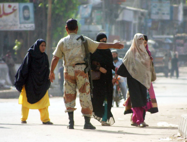 a ranger directs women in lyari on tuesday during a lockdown as part of a clean up operation photo mohammad azeem exress a ranger directs women in lyari on tuesday during a lockdown as part of a clean up operation photo mohammad azeem exress