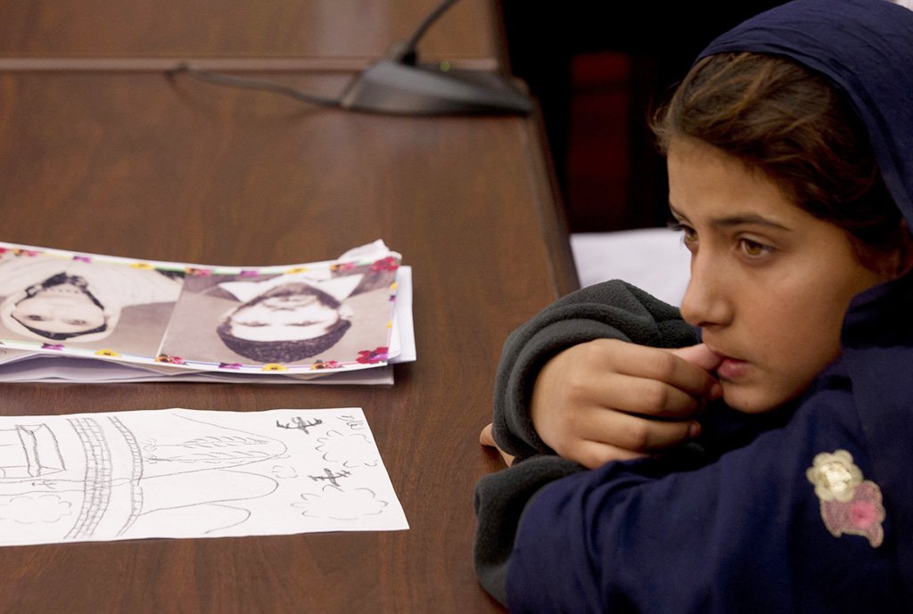 nine year old nabila rehman sits in front of pictures of her relatives killed in drone strikes at the start of a news conference on capitol hill in washington on tuesday photo reuters