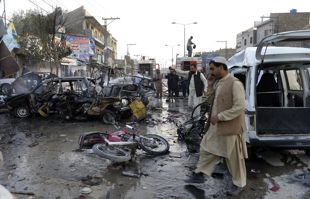 bystanders gather at the site of a bomb explosion in quetta on october 30 2013 photo afp