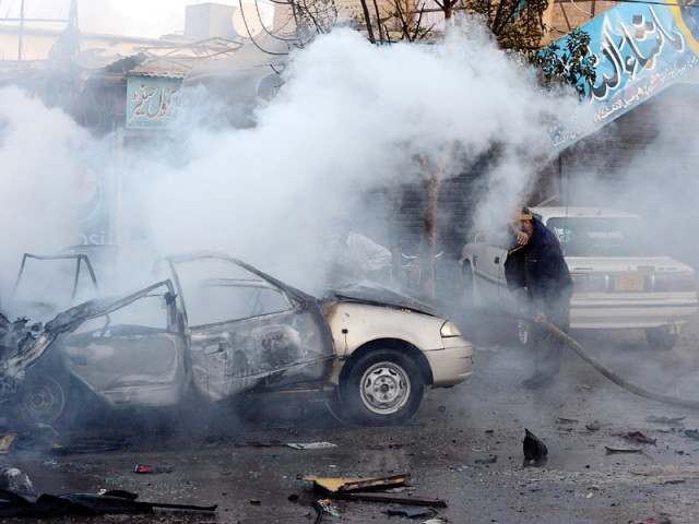 a firefighter extinguishes burning vehicles after a bomb explosion in quetta on wednesday photo afp a firefighter extinguishes burning vehicles after a bomb explosion in quetta on wednesday photo afp