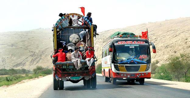 Devotees return to their hometowns after attending the three-day urs of Hazrat Lal Shahbaz Qalandar in Sehwan. PHOTO: APP