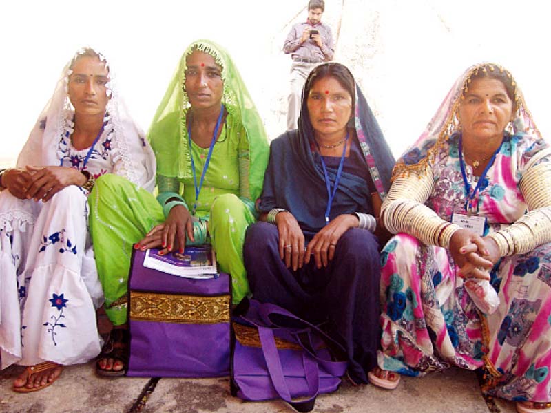 rural women huddled together to seek more rights photos express