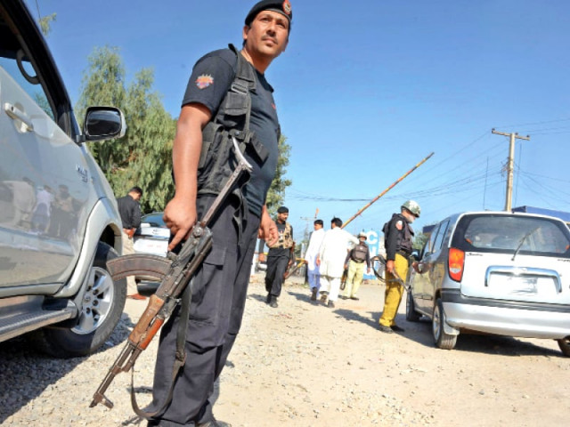 policemen check commuters at a security checkpoint in the provincial capital photo afp policemen check commuters at a security checkpoint in the provincial capital photo afp