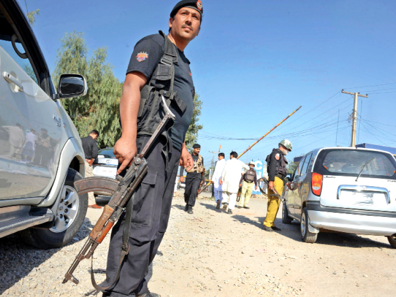 policemen check commuters at a security checkpoint in the provincial capital photo afp