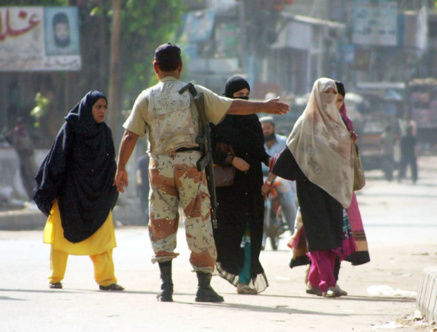 a ranger directs women in lyari on tuesday during a lockdown as part of a clean up operation photo mohammad azeem exress a ranger directs women in lyari on tuesday during a lockdown as part of a clean up operation photo mohammad azeem exress