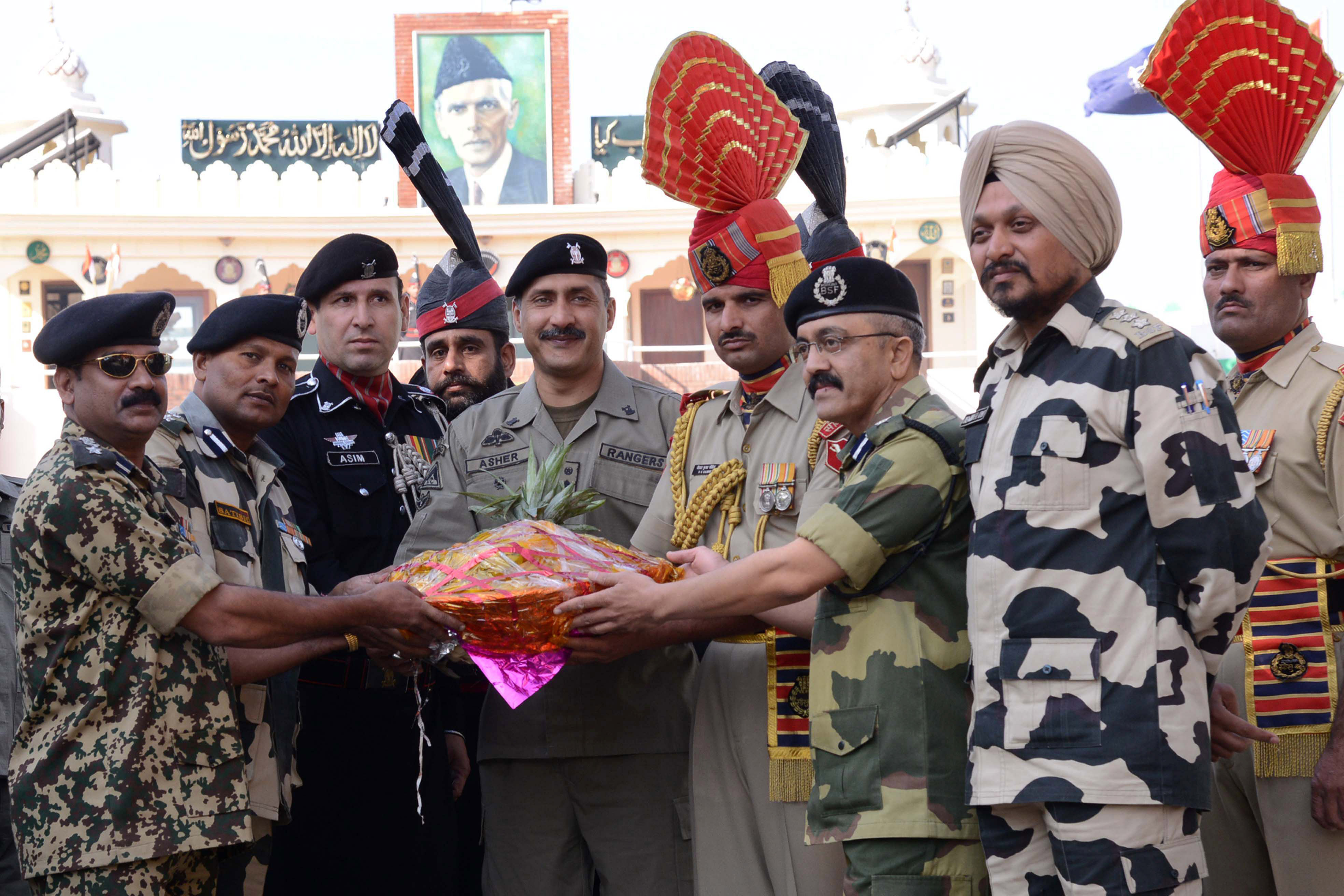 ndian border security force bsf officiating deputy inspector general dig baby joseph l bsf commandant satish kumar 2l along with bsf officers gives a gift to pakistani ranger wing commander asher khan c on diwali at the india pakistan wagah border on november 3 2013 photo afp