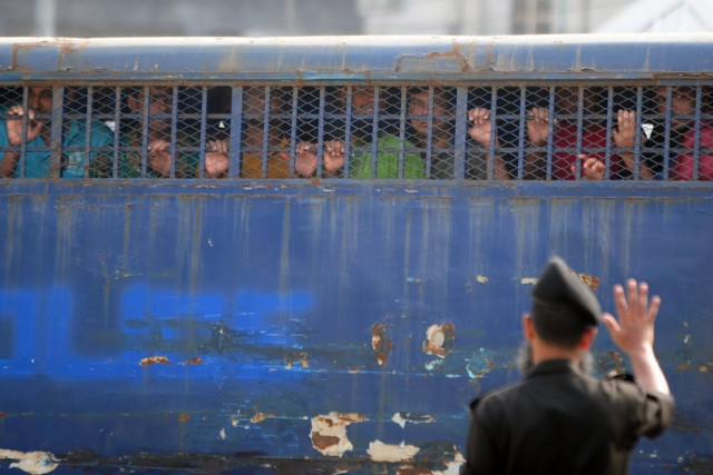handcuffed bangladesh rifles bdr soldiers look through a prison van as they arrive at the special court in dhaka on november 5 2013 photo afp handcuffed bangladesh rifles bdr soldiers look through a prison van as they arrive at the special court in dhaka on november 5 2013 photo afp