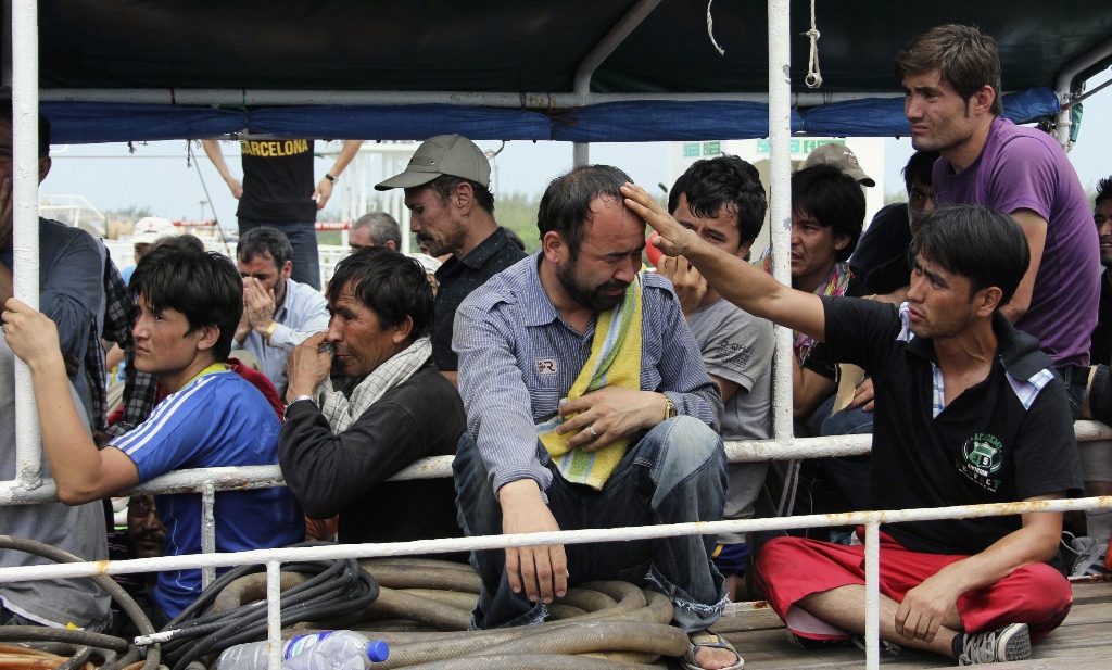 file photo of asylum seekers from afghanistan iraq and iran crying as indonesian officers force them to leave the australian vessel hermia photo reuters