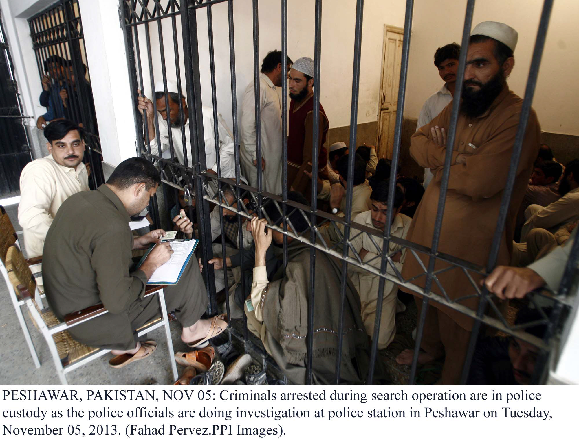 suspects arrested in a search operation having their details registered at a police station in peshawar photo ppi file