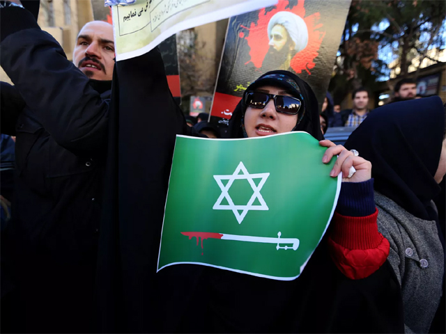 an iranian woman holds an anti saudi placard at a protest outside the saudi embassy in tehran photo afp