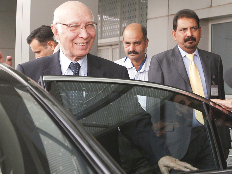 sartaj aziz exits the ceremonial lounge following his arrival at the indira gandhi international airport in new delhi photo afp