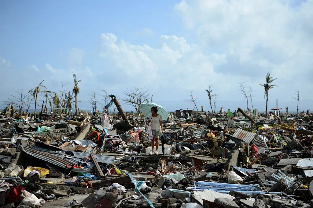 a surivor walks among the debris of houses destroyed by super typhoon haiyan in tacloban in the eastern philippine island of leyte on november 11 2013 photo afp a surivor walks among the debris of houses destroyed by super typhoon haiyan in tacloban in the eastern philippine island of leyte on november 11 2013 photo afp