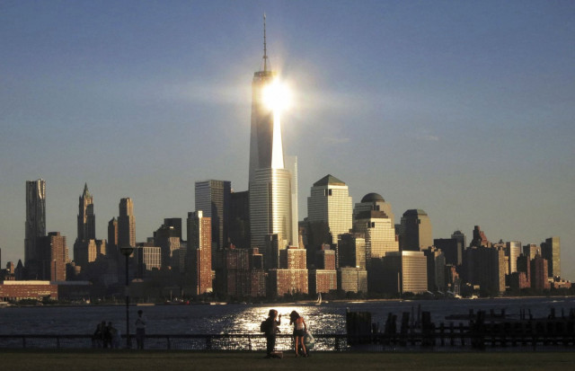 sun reflects off new york 039 s one world trade center as people stand in a park in hoboken new jersey in this file photo taken september 29 2013 photo reuters sun reflects off new york 039 s one world trade center as people stand in a park in hoboken new jersey in this file photo taken september 29 2013 photo reuters