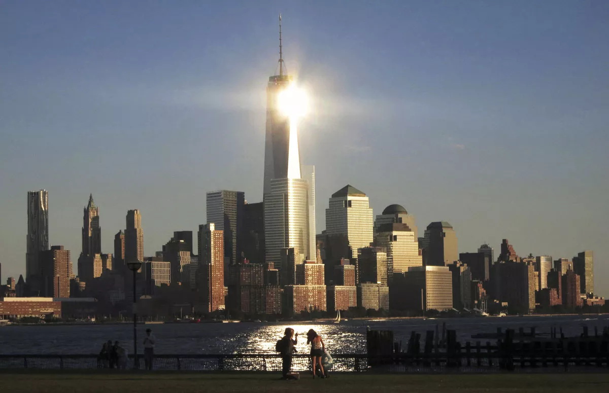 sun reflects off new york 039 s one world trade center as people stand in a park in hoboken new jersey in this file photo taken september 29 2013 photo reuters sun reflects off new york 039 s one world trade center as people stand in a park in hoboken new jersey in this file photo taken september 29 2013 photo reuters