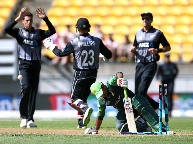 mitchell santner of new zealand celebrates with glenn phillips after taking the wicket of sarfraz ahmed in the 1st t20 jan 22 2018 photo getty