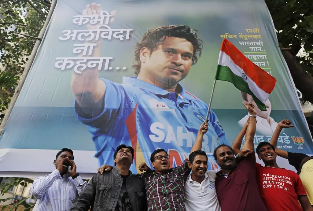 cricket fans holding an indian national flag shout slogans in front of a billboard of cricketer sachin tendulkar outside a stadium in mumbai november 14 2013 photo reuters cricket fans holding an indian national flag shout slogans in front of a billboard of cricketer sachin tendulkar outside a stadium in mumbai november 14 2013 photo reuters