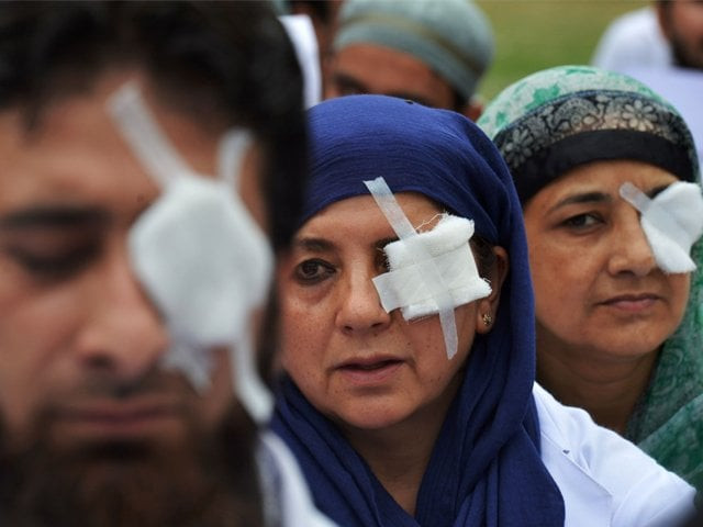 kashmiri doctors and paramedics their eyes covered by patches protested at a hospital in srinagar photo afp kashmiri doctors and paramedics their eyes covered by patches protested at a hospital in srinagar photo afp