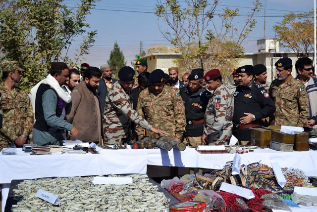 fc commander lt general nasir khan observes the weapons seized during the raid photo online fc commander lt general nasir khan observes the weapons seized during the raid photo online