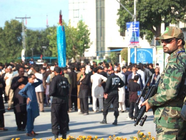security officials guard a procession held during muharram photo muhammad javaid express