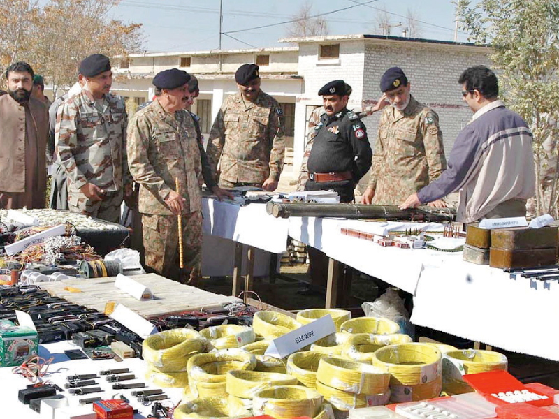 commander southern command lt gen nasser khan janjua inspecting explosives and weapons seized by fc inspector general fc major general ejaz shahid and home minister sarfraz bugti are also present photo app