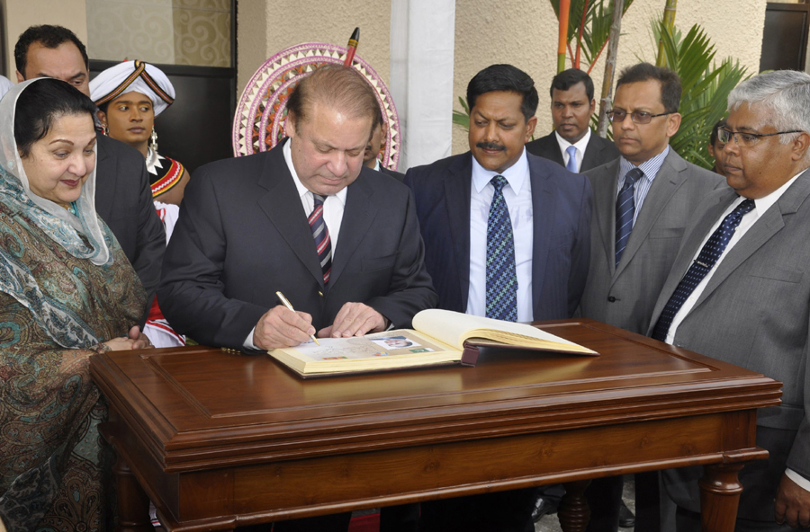 nawaz sharif writing in the guestbook on arrival in sri lanka photo pid