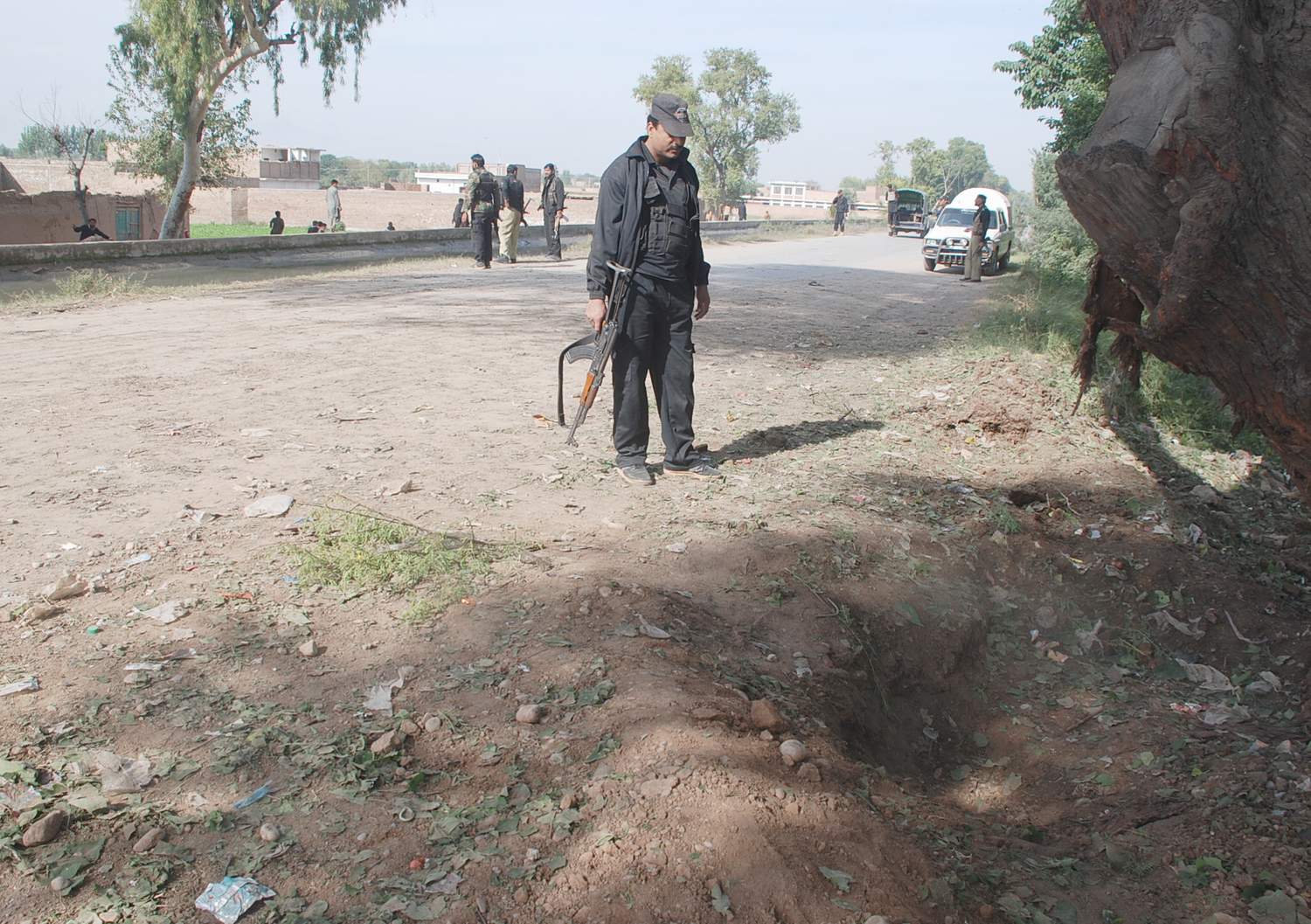 a policeman inspects the site of an explosion in safan area on kohat road in peshawar photo iqbal mamoond express