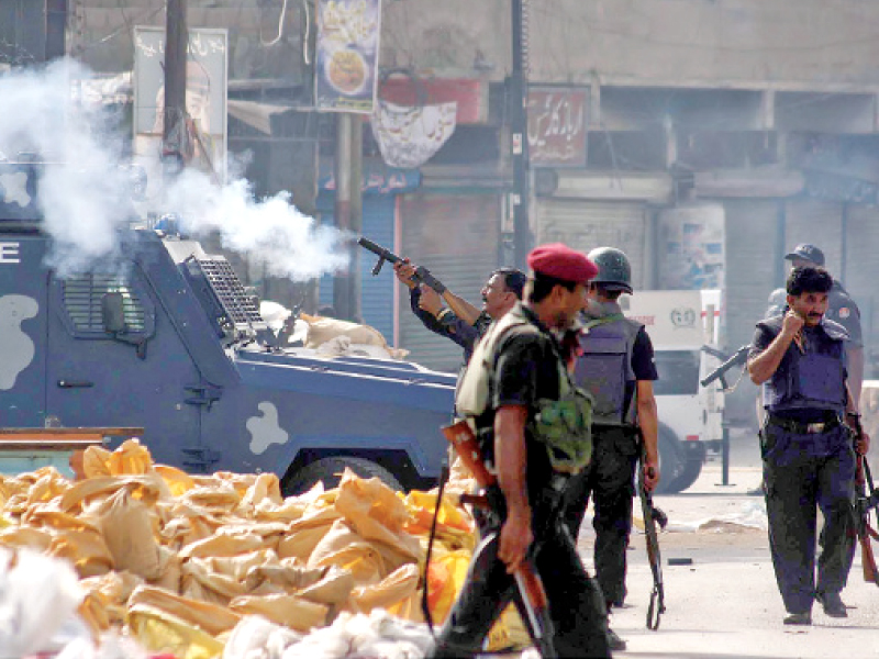 law enforcers fire tear gas shells during a targeted operation conducted earlier in lyari on saturday evening police and the rangers cordoned off gangster baba ladla s strongholds and started an operation to control the gang war between groups of ladla and uzair baloch photo file