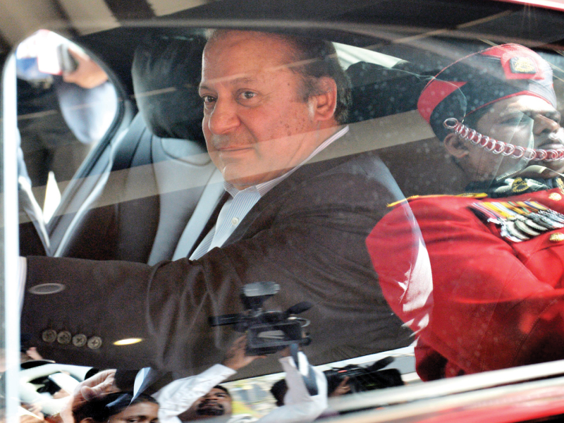 a guard is reflected on the vehicle of prime minister nawaz sharif as he leaves a working session of the commonwealth heads of government meeting in colombo on saturday photo afp