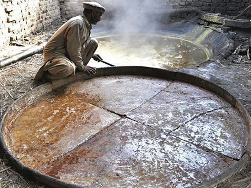 a gurhi transfers the gurh to a mud plate to let it cool at a local sugar mill in charsadda photo farahnaz zahidi express