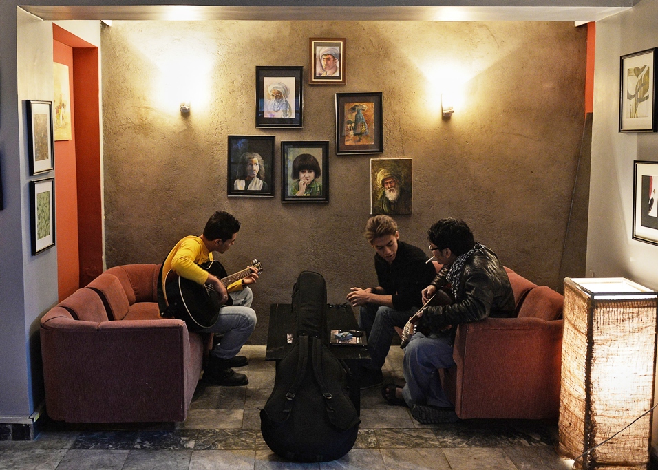 in this picture taken on october 22 2013 afghan music students chat and practice the guitar at quot kabul school of rock quot in kabul founded two years ago in a living room in the afghan capital the school has grown into a busy youth club based at an arts centre with a recording studio and 35 students mastering singing the guitar and drums photo afp